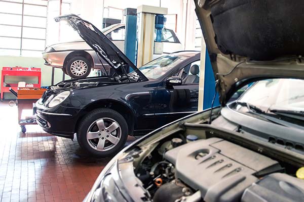 Mechanic tightening a bolt on a car engine, demonstrating precision in auto repair in San Antonio, TX.